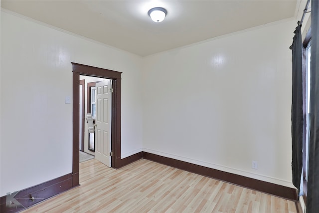 unfurnished room featuring crown molding and light hardwood / wood-style flooring