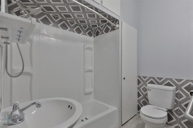 full bathroom with sink, tile patterned flooring, toilet, and washtub / shower combination