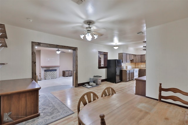 carpeted dining area with ceiling fan