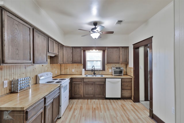 kitchen with light hardwood / wood-style flooring, white appliances, butcher block counters, ceiling fan, and sink