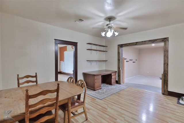 dining area with light colored carpet and ceiling fan