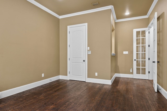 spare room featuring crown molding and dark wood-type flooring