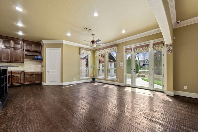 unfurnished living room featuring ceiling fan, crown molding, and dark wood-type flooring