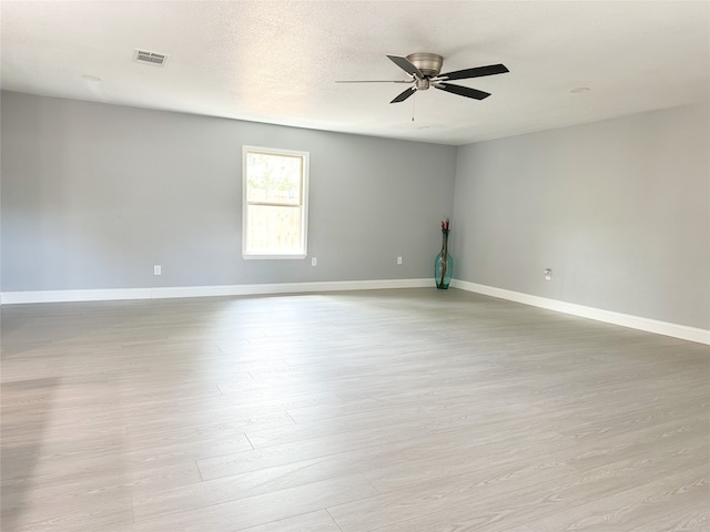 empty room with light hardwood / wood-style flooring and ceiling fan