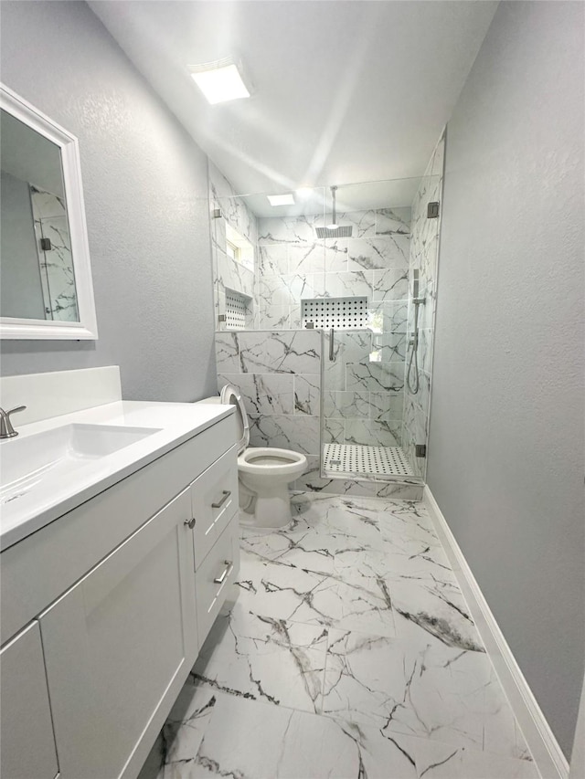 full bath featuring vanity, marble finish floor, toilet, baseboards, and a marble finish shower