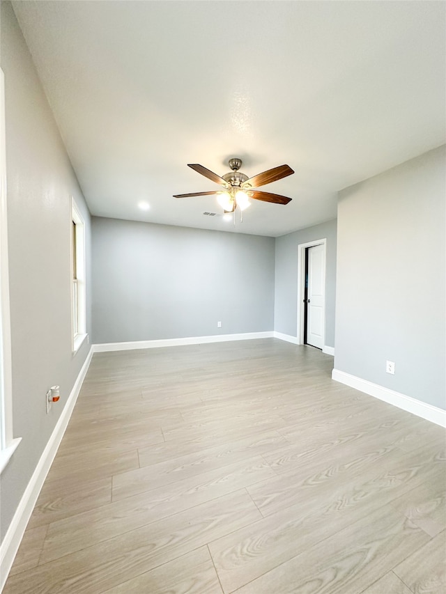 unfurnished room with ceiling fan and light hardwood / wood-style flooring