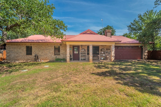 rear view of house featuring a garage and a yard