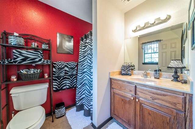 bathroom featuring tile floors, oversized vanity, and toilet