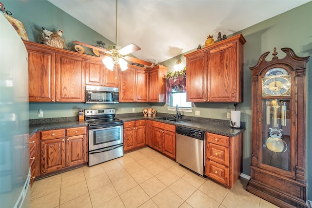 kitchen with light tile flooring, stainless steel appliances, ceiling fan, sink, and lofted ceiling