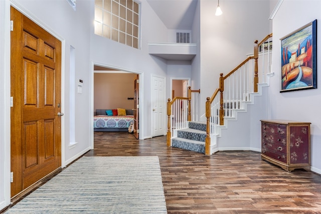 foyer featuring a high ceiling and dark hardwood / wood-style floors