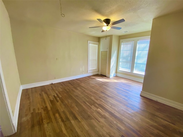 spare room featuring dark hardwood / wood-style flooring and ceiling fan