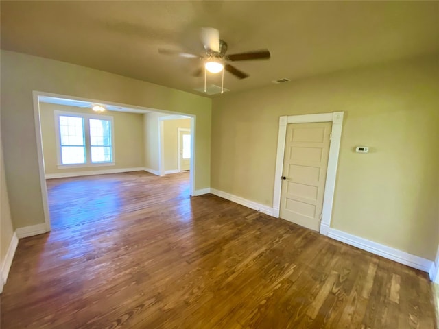 empty room featuring ceiling fan and dark wood-type flooring