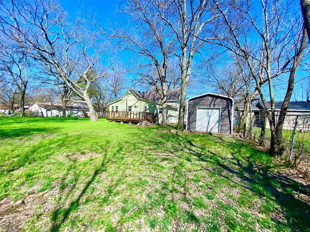 view of yard featuring a deck and a garage