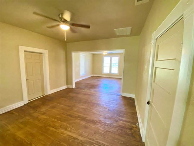 unfurnished room featuring ceiling fan and dark hardwood / wood-style flooring