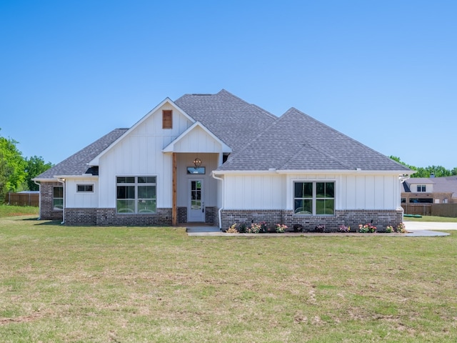 modern inspired farmhouse with a front lawn