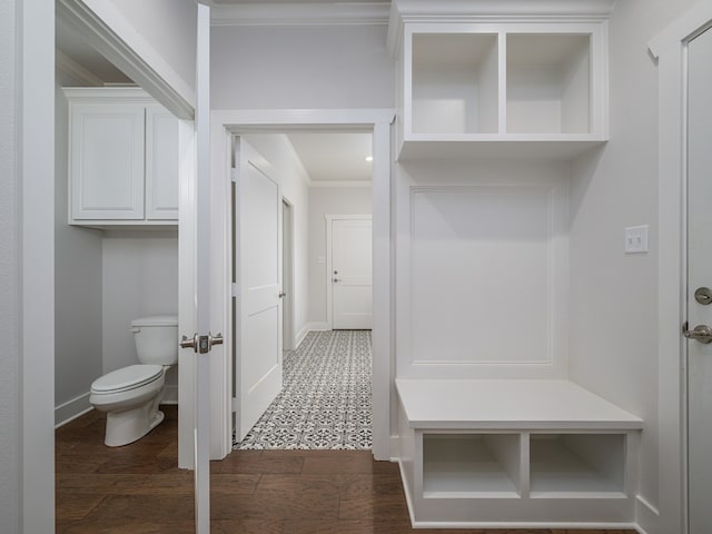 mudroom featuring crown molding and dark tile flooring