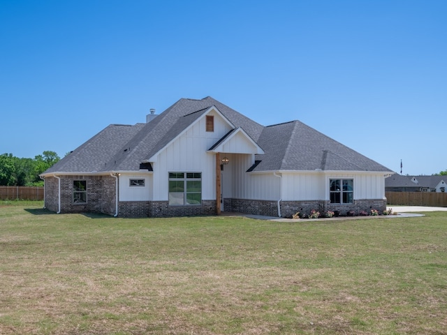 modern inspired farmhouse with a front lawn