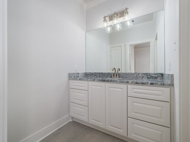 bathroom with tile flooring, ornamental molding, and vanity