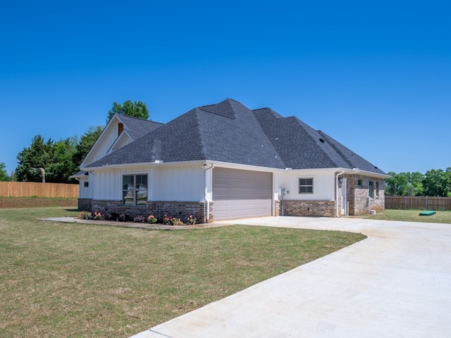 view of front facade with a front yard and a garage