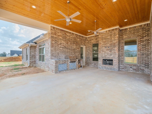 view of terrace with exterior kitchen, ceiling fan, and a grill