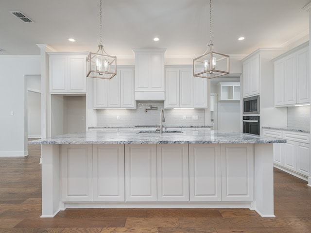 kitchen with white cabinets, black oven, and dark hardwood / wood-style floors