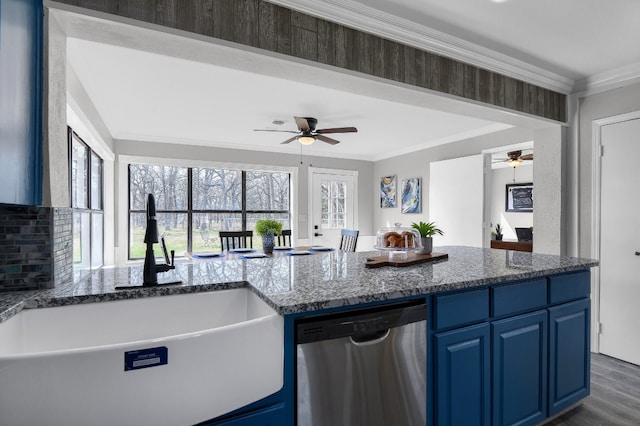 kitchen with blue cabinetry, stainless steel dishwasher, ceiling fan, dark stone countertops, and sink