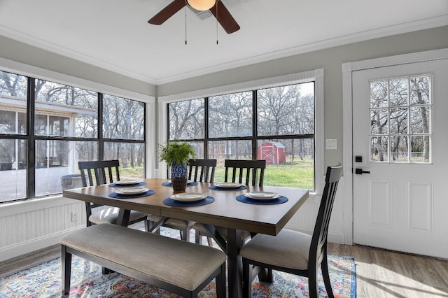 sunroom / solarium featuring ceiling fan and a wealth of natural light