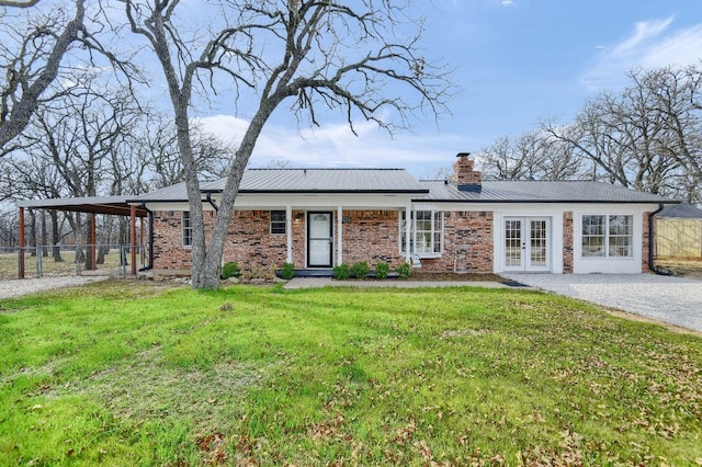 single story home with french doors and a front lawn