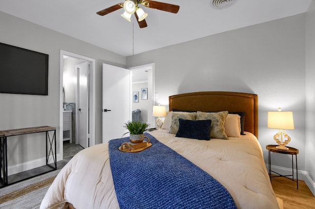 bedroom featuring ceiling fan, connected bathroom, and hardwood / wood-style floors