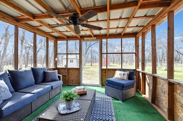 sunroom with beam ceiling and ceiling fan