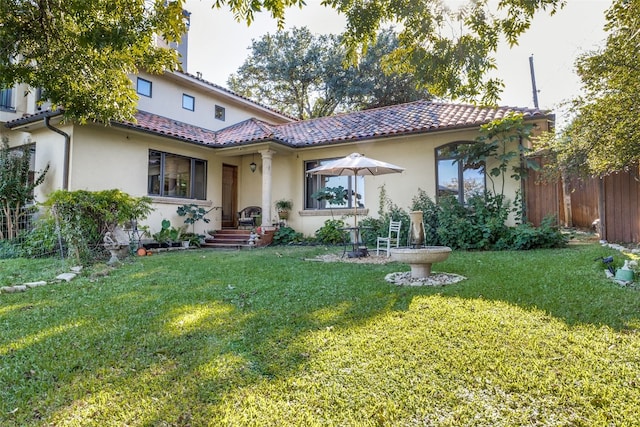 rear view of house with a yard