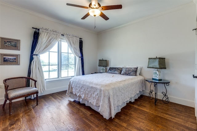 bedroom with dark hardwood / wood-style flooring, ceiling fan, and ornamental molding