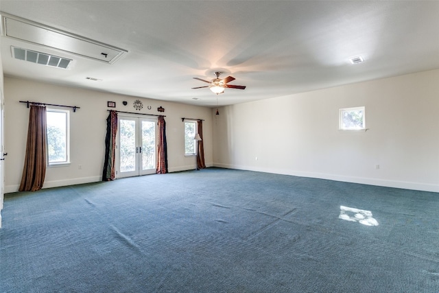 carpeted empty room with ceiling fan and french doors