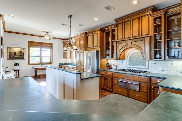 kitchen featuring appliances with stainless steel finishes, backsplash, ornamental molding, ceiling fan, and decorative light fixtures