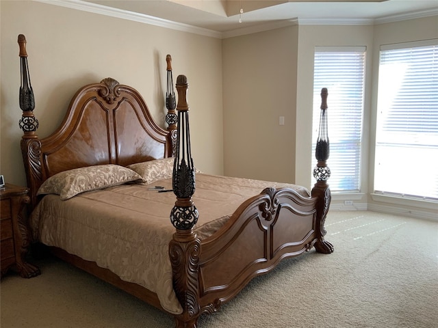 bedroom featuring multiple windows, crown molding, and light carpet