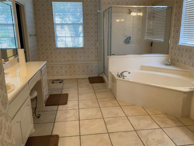 bathroom featuring plenty of natural light, tile flooring, shower with separate bathtub, and vanity