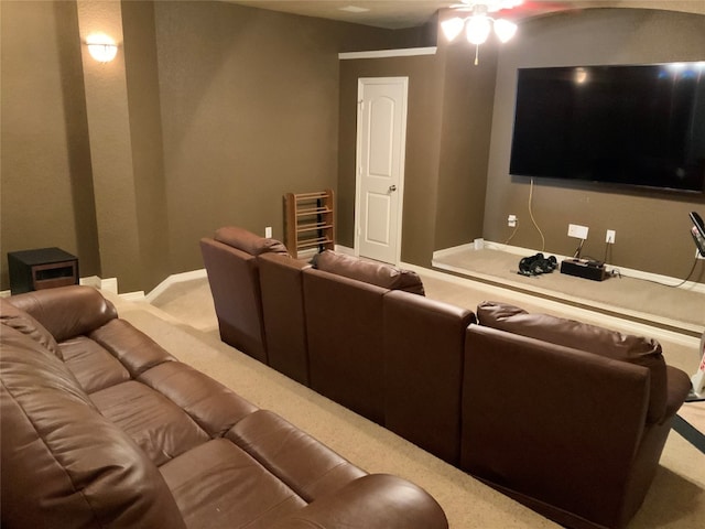 carpeted cinema featuring ceiling fan