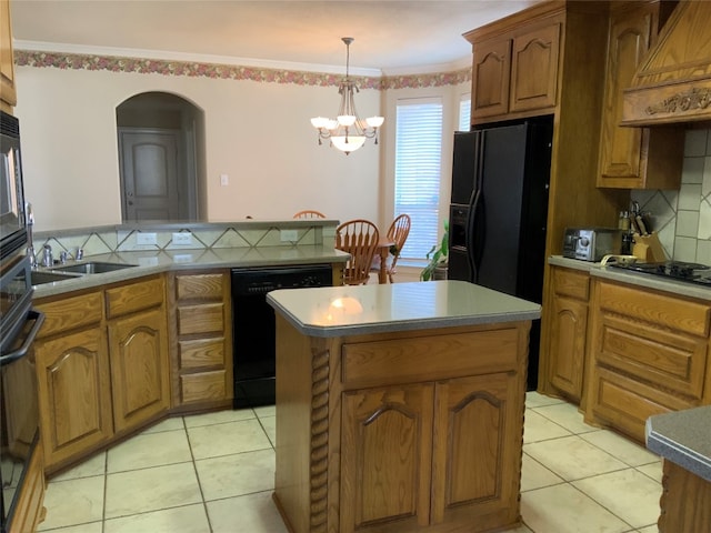 kitchen featuring backsplash, black appliances, custom exhaust hood, a chandelier, and a kitchen island