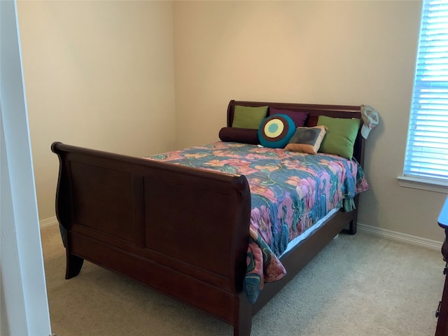 bedroom featuring light carpet