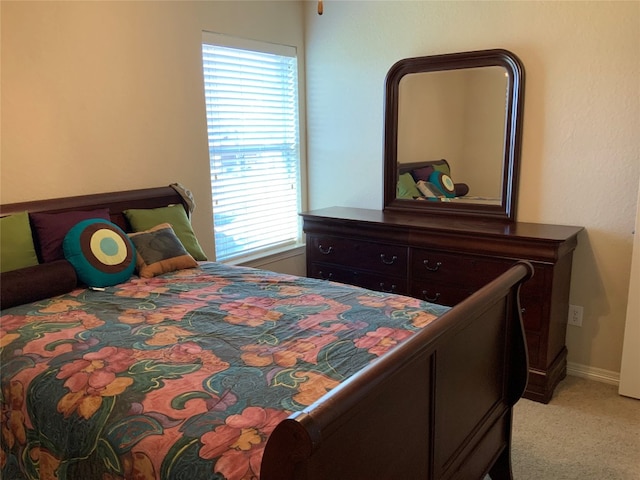 bedroom featuring light carpet and multiple windows