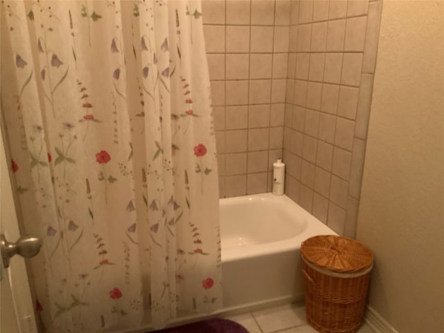 bathroom featuring tile flooring and shower / bath combo with shower curtain