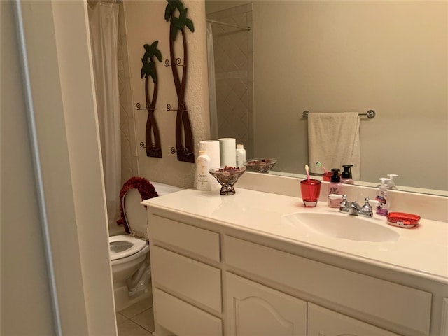 bathroom with toilet, tile flooring, and vanity