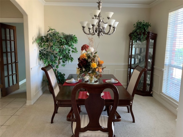 tiled dining room with a notable chandelier and crown molding