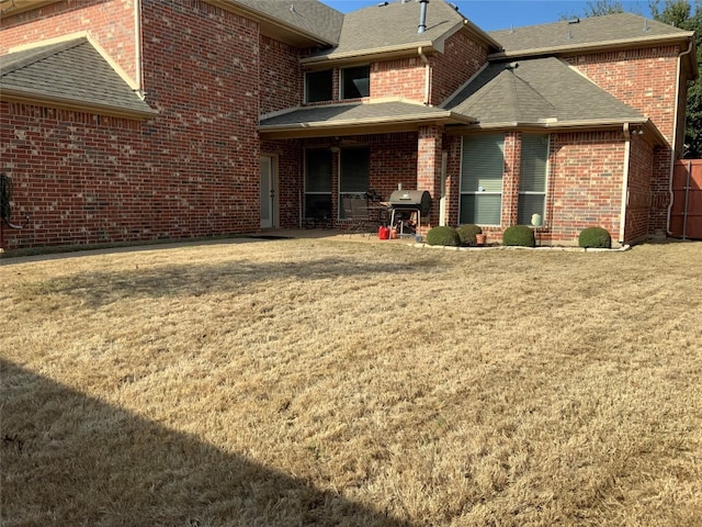 back of house with a yard