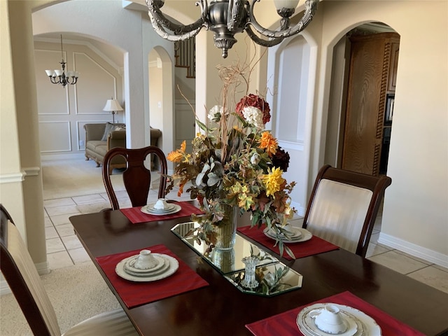 dining space featuring light tile floors and a notable chandelier