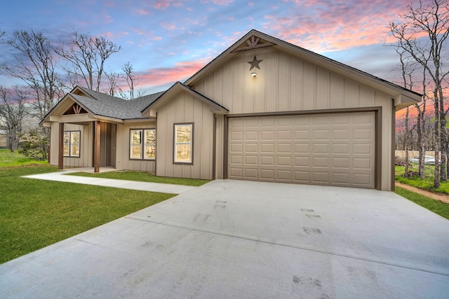 single story home with a garage and a yard