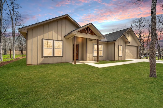 view of front of home featuring a garage and a yard