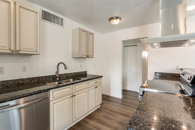 kitchen featuring appliances with stainless steel finishes, dark stone counters, sink, island exhaust hood, and dark hardwood / wood-style floors