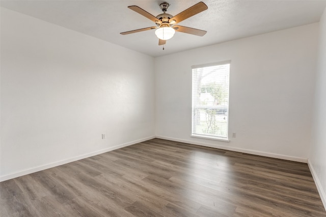 unfurnished room featuring ceiling fan and dark hardwood / wood-style floors