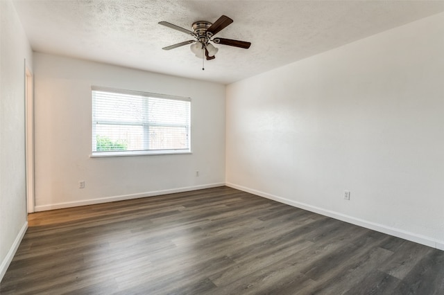 empty room with ceiling fan, dark hardwood / wood-style floors, and a textured ceiling